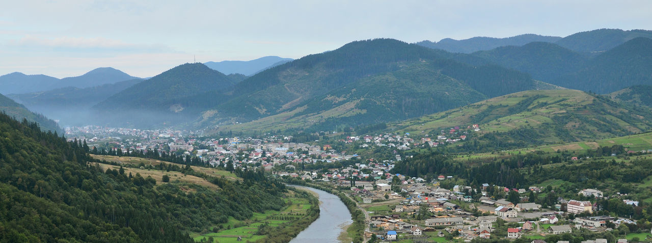High angle view of townscape and mountains against sky