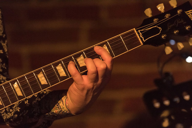 Cropped hand playing guitar