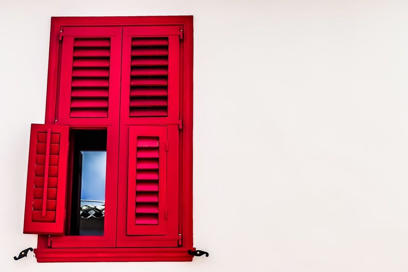 Red window on white wall