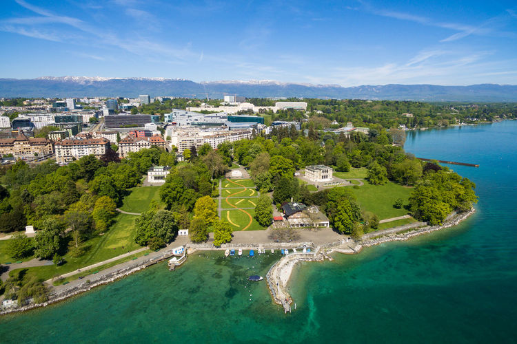 High angle view of buildings by sea against sky