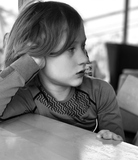 Close-up of girl looking away while sitting at table