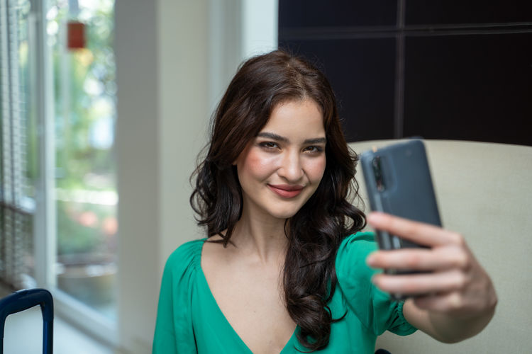Portrait of young woman using smart phone