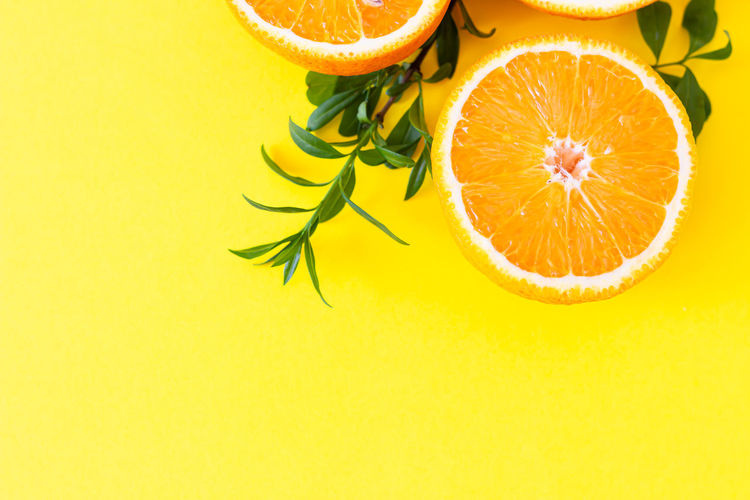 Directly above shot of orange fruit on yellow background