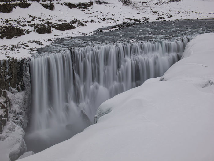 Scenic view of snow covered waterfall