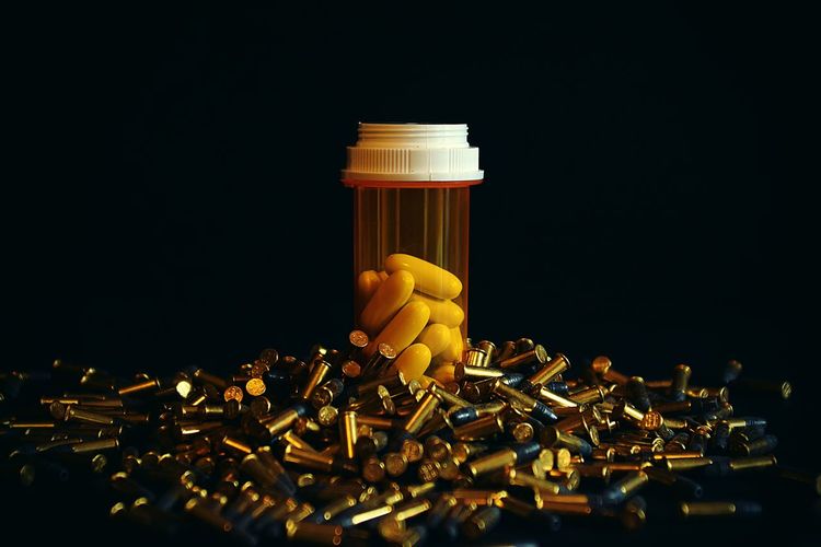 Close-up of pills in container against black background