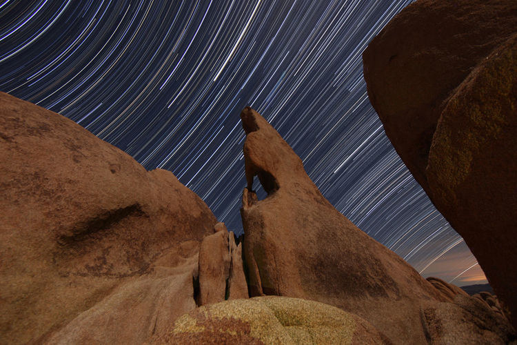 Low angle view of rock formations at night