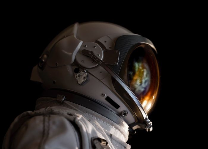Close-up of astronaut against black background
