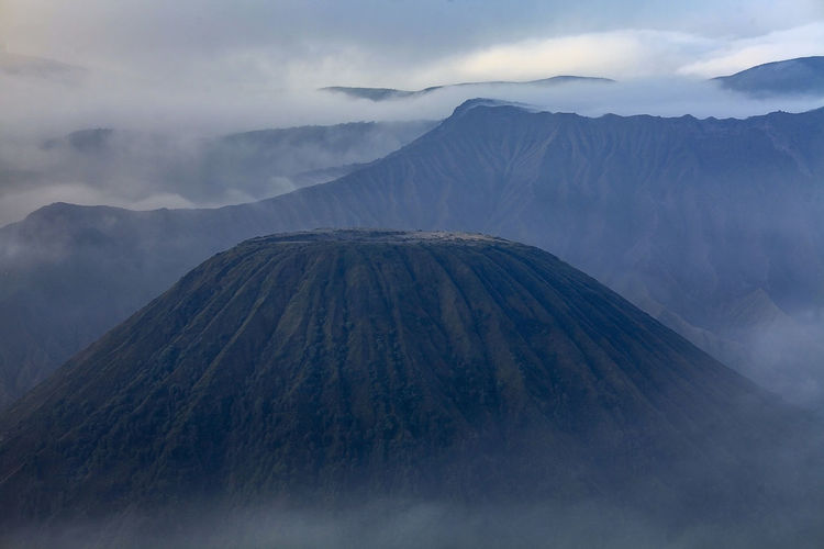 Volcanic landscape against sky 