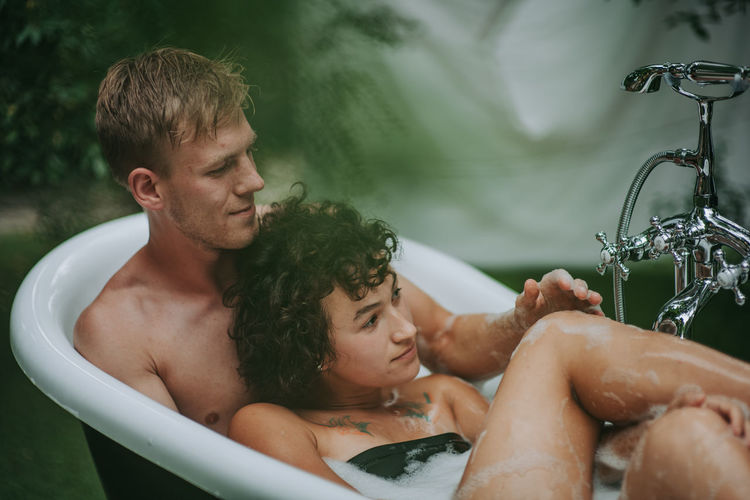 Couple in bathtub outdoors