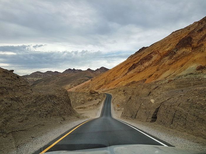 Road amidst mountains against sky in the hot death valley