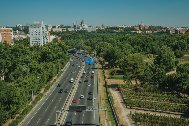 High angle view of highway amidst trees in city