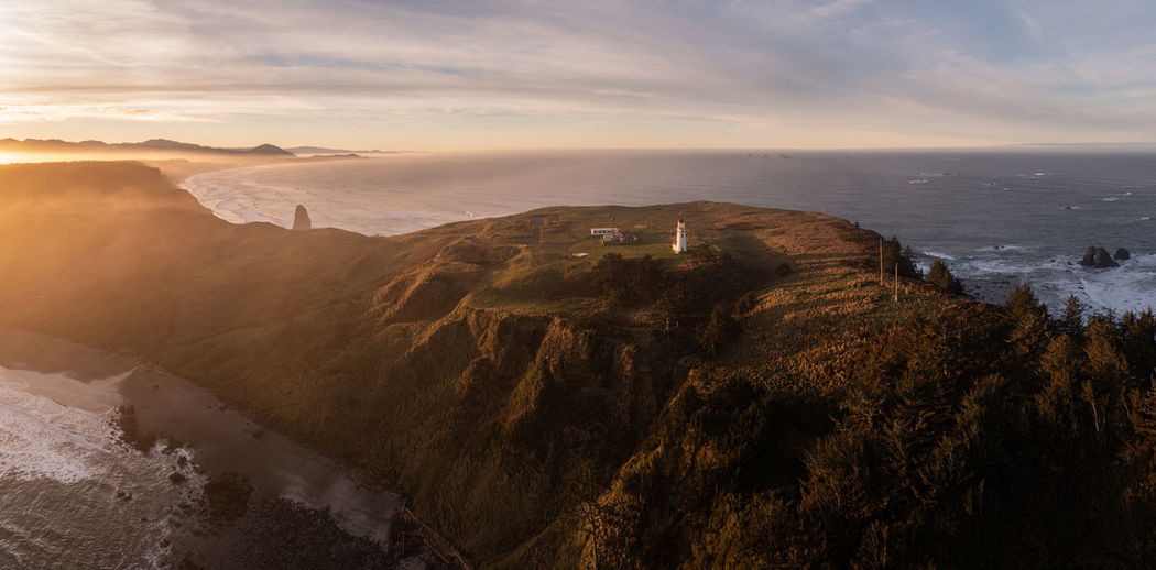Cape blanco lighthouse at the southern oregon coast at sunrise. dramatic aerial photo.