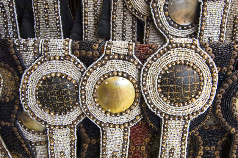 Ornate belts displayed at market for sale