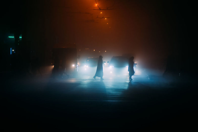 Silhouette people at illuminated nightclub