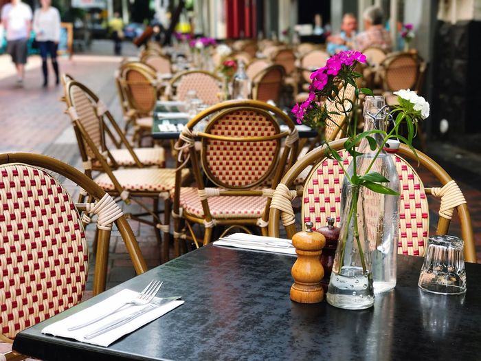 Chairs and table arranged at sidewalk cafe