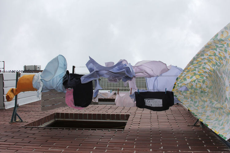 Rear view of clothes drying on footpath