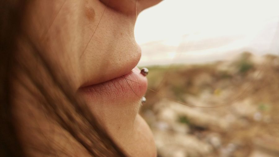 Extreme close-up of womans pierced lip