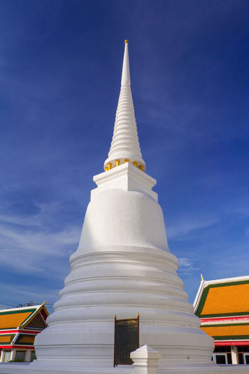 Low angle view of white pagoda against blue sky