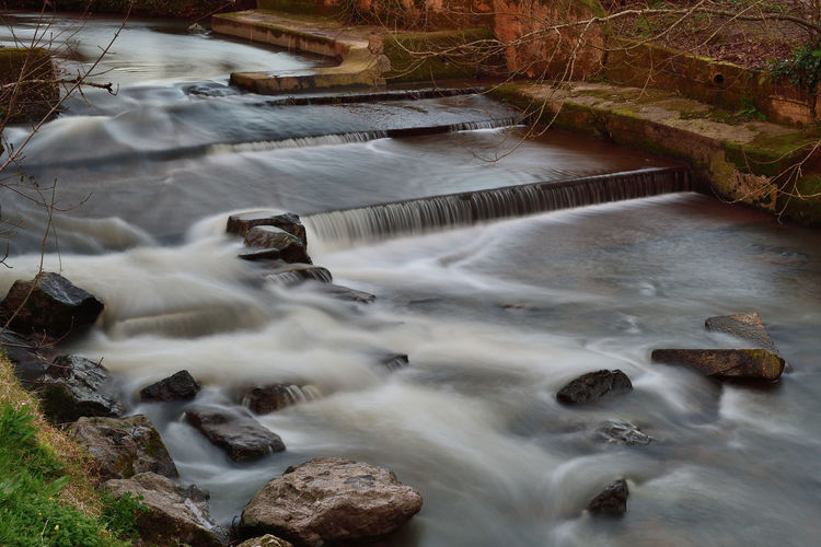 Long exposure of the river sid flowing into sidmouth in devon 