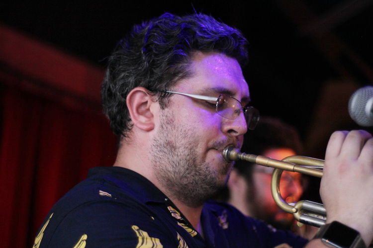 Close-up of man playing trumpet on stage