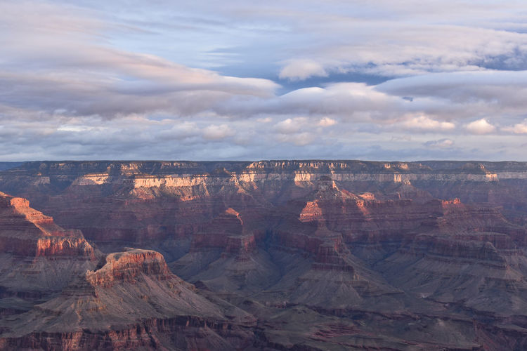 Scenic view of grand canyon landscape against cloudy sky
