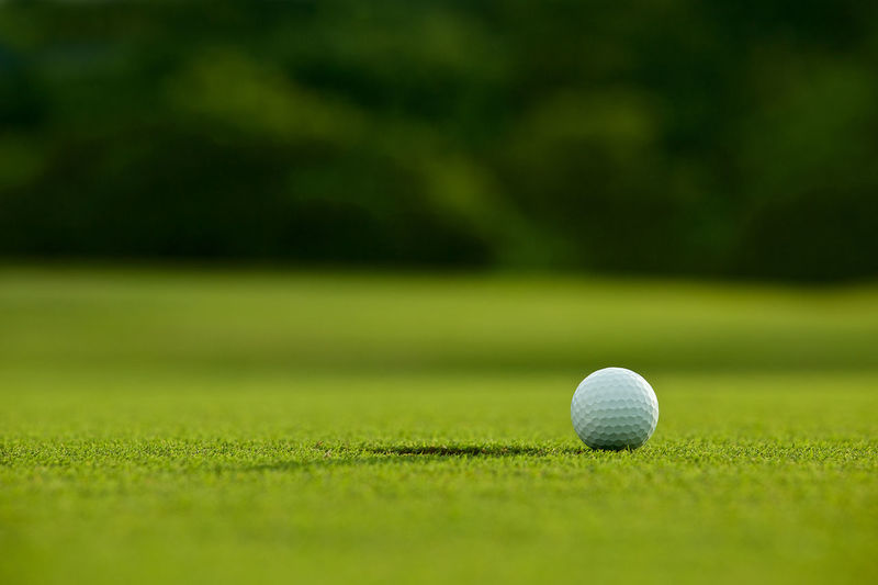 Close-up of golf ball on playing field