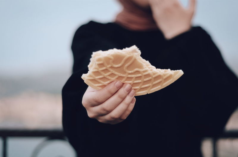 Midsection of person holding ice cream