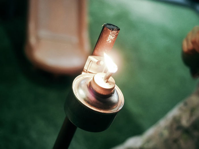 High angle view of burning candle on table