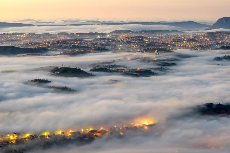 Aerial view of cityscape and cloudscape during sunset