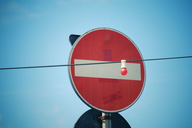 Low angle view of traffic sign against clear sky