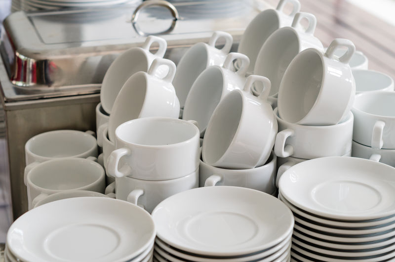 Close-up of crockery arranged on buffet table in restaurant