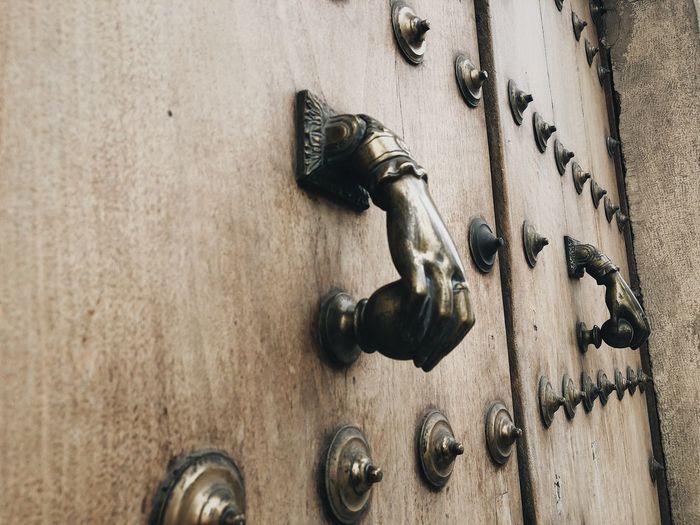 Close-up of knob on wooden door