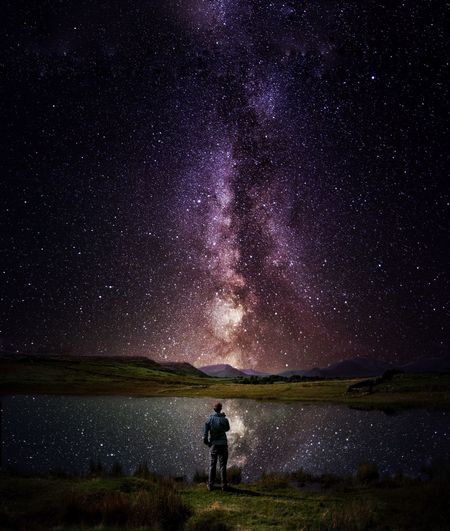 FULL LENGTH OF WOMAN STANDING ON FIELD AGAINST SKY