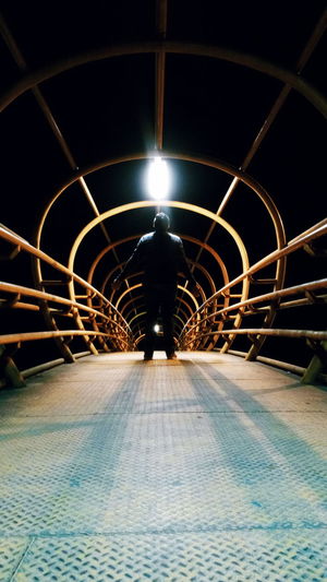 Illuminated tunnel at night
