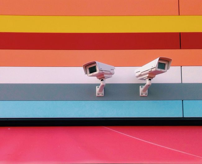 Security camera on multi colored house wall