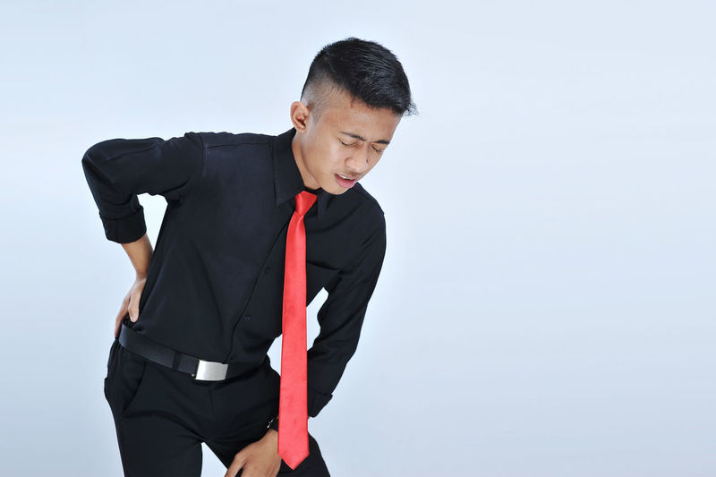Young asian business man having back pain