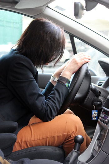 Side view of woman sitting in car