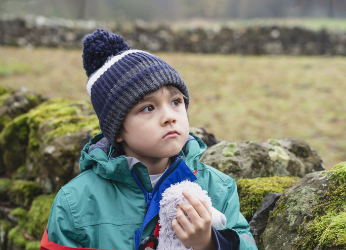 Portrait of cute boy in park during winter