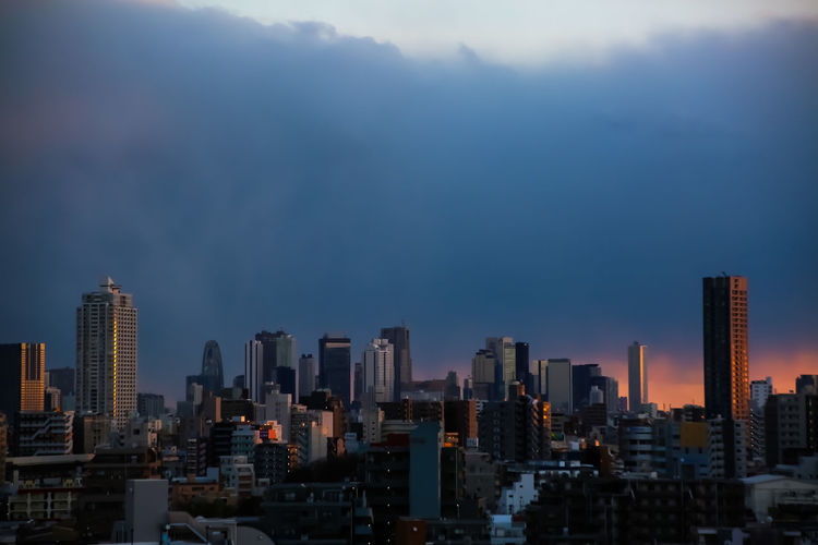 Modern buildings in city against sky