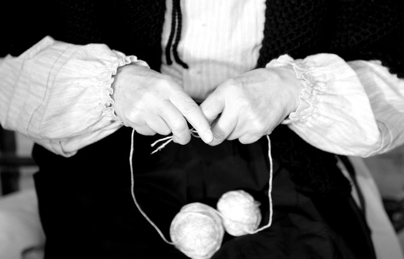 Midsection of woman holding ball of wool