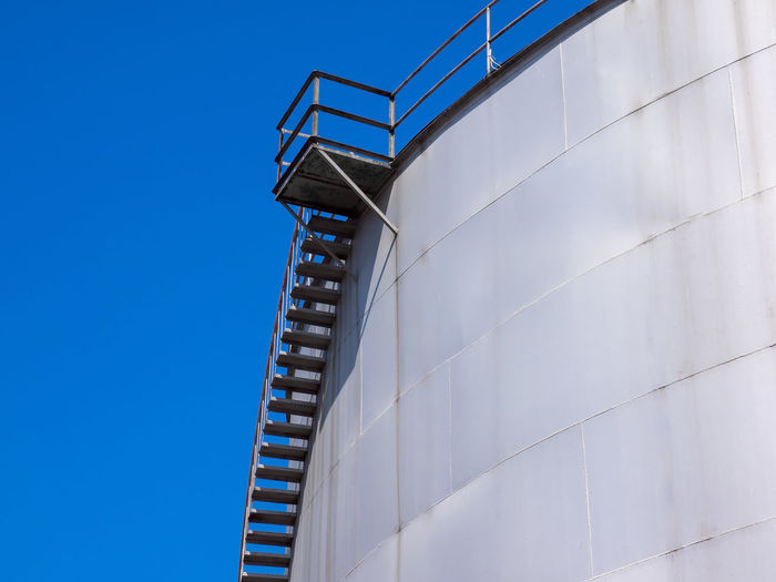 Low angle view of staircase on storage tank