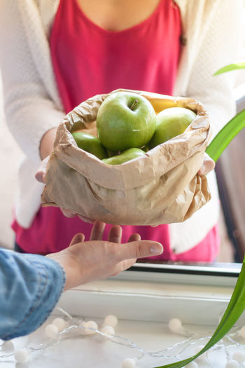 Close-up of people with granny smith apple