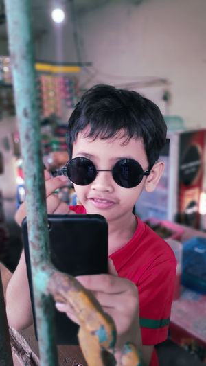 Portrait of boy using mobile phone