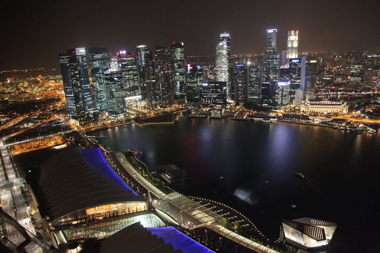 Aerial view of city lit up at night