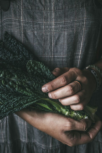 Person holding kale leaves