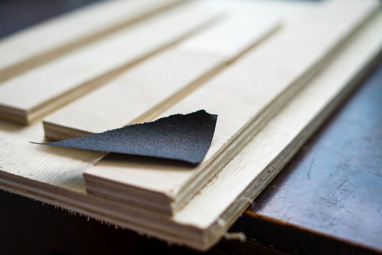 Close-up of sand paper with wood in workshop