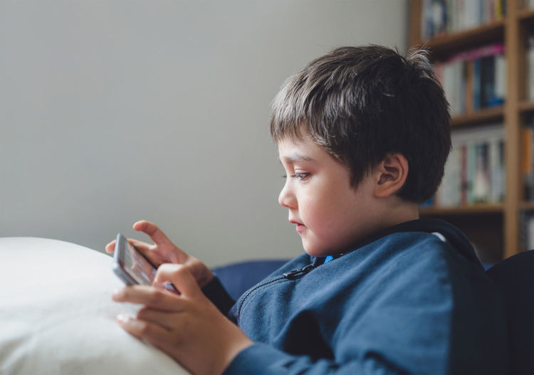 Portrait of boy looking at camera at home