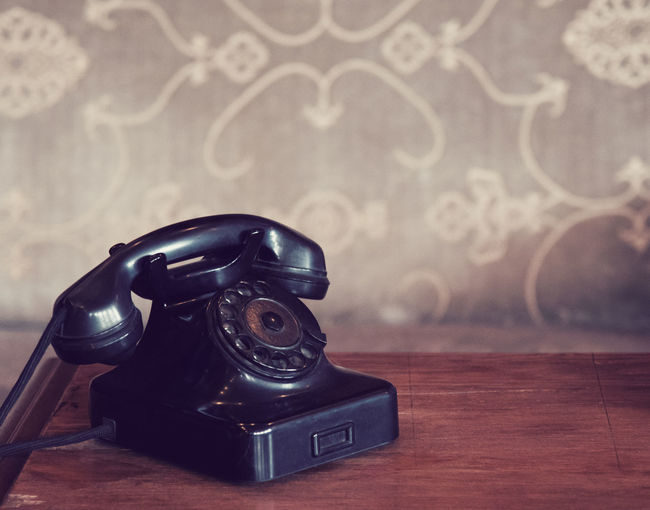 Close-up of telephone on table