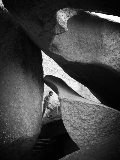Man climbing stairs between rock formations