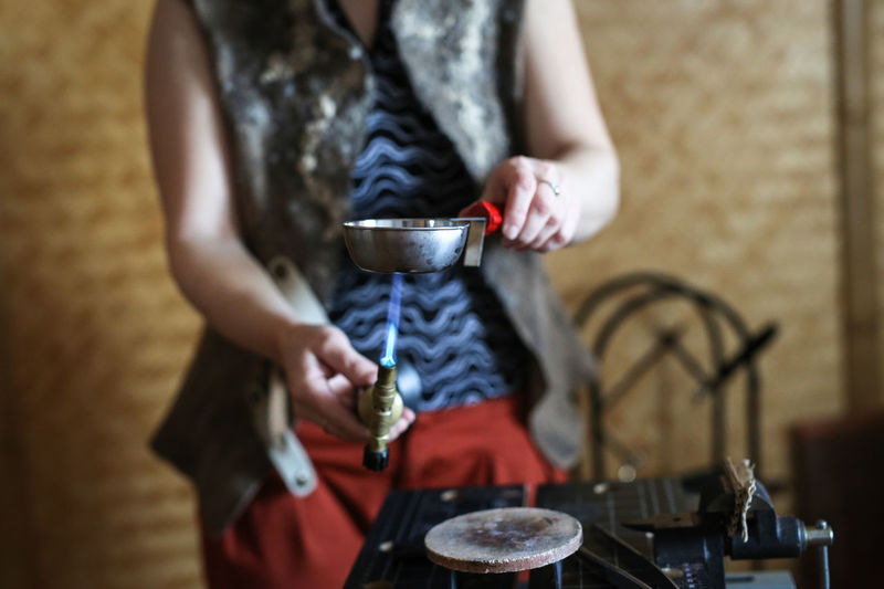 Home workshop girl master roasting on a gas burner in a meta-liter scoop boils water with a copper 